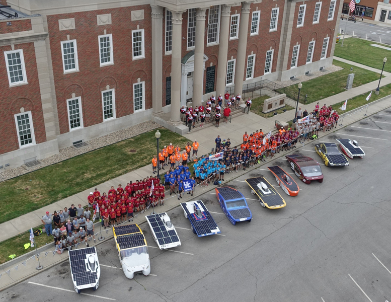 Aerial view of the ASC solar cars lined up together at curbside, each with a unique shape and design